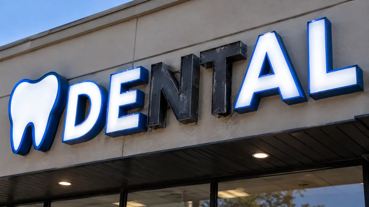Dental office channel letter sign with the N and T unlit before repair